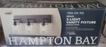 Hampton Bay Regan 21 In. 3-LIGHT Espresso Finish Vanity With Clear Glass. Fixed Price $49.97.