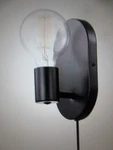 Novagratz Linus 4.25 In. 1-LIGHT Matte Black Wall Sconce Plug-in Or Hardwire. Fixed Price $19.95.