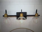 Lnc 22.5 In. 3-LIGHT Modern Aged Brass And Black Bathroom Vanity W Globe. Fixed Price $42.25.